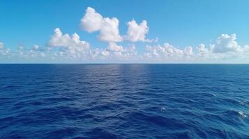 A view of the ocean from above with clouds in the sky photo