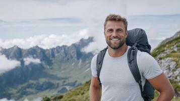 A man with a backpack standing on a mountain photo