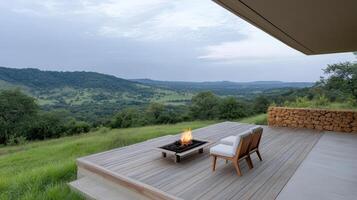 A wooden deck with a fire pit overlooking the mountains photo