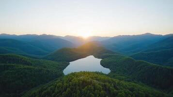 Aerial view of a lake surrounded by mountains at sunset photo