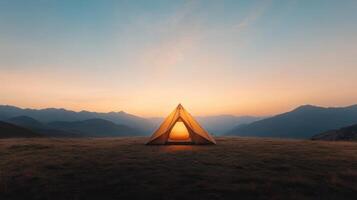 A tent is lit up in the middle of a field photo
