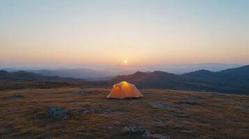 Camping tent on the mountain at sunset photo