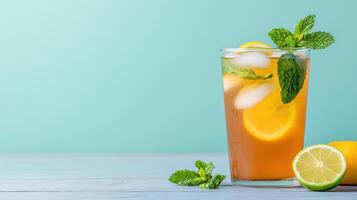 Lemonade with mint leaves and lime on a blue background photo