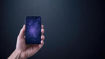 Hand holding a smartphone with galaxy space background photo