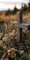 Wooden cross surrounded by flowers in a serene setting photo