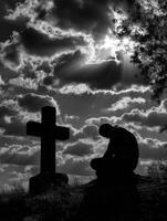 Contemplative moment at the cross during sunset photo