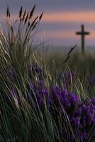 Vibrant wildflowers near a wooden cross at twilight photo