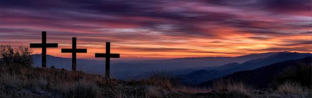 Sunset over three crosses on a hillside in a tranquil landscape photo