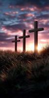 Sunset view of wooden crosses on grassy hill photo