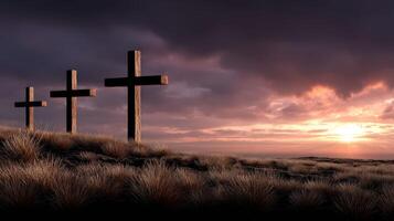 Three wooden crosses on a hill with a sunset photo