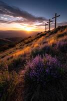 Three crosses on the hillside at sunset photo