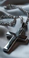 A cross necklace laying on a cloth photo
