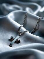 A silver cross on a silver chain photo
