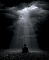 Man meditating in dark landscape under beams of light photo