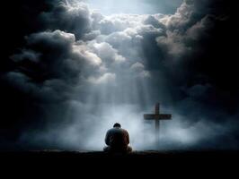 Person meditates in front of a cross under cloudy sky photo
