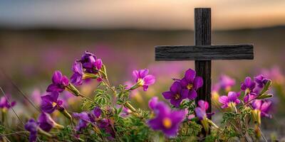 Cross surrounded by vibrant wildflowers during sunset photo
