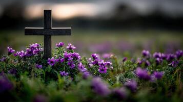 Cross surrounded by purple flowers in a tranquil field photo