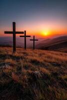 Sunset view of three crosses on a hilltop photo