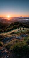 Sunset view over rolling hills with wooden crosses in foreground photo