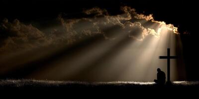 Solitary figure kneeling near a cross under dramatic clouds photo