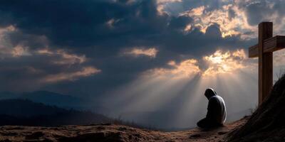 Contemplation at sunset near a cross on a serene hillside photo