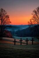Four crosses in a field at sunset photo