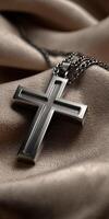 Silver cross pendant resting elegantly on soft fabric photo