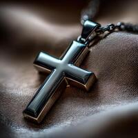 Shiny cross pendant resting on soft fabric background photo