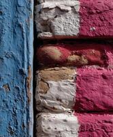 Colorful textured wall with peeling paint in urban setting photo
