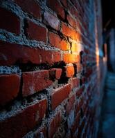 Light casts shadows on textured red brick wall at night photo