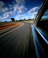 Dynamic view of a car speeding around a winding road photo
