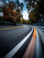 Curving racetrack with blurred motion in autumn landscape photo