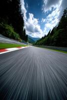 Racing down a scenic track surrounded by trees and mountains photo