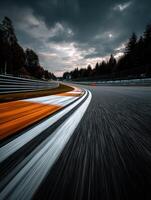 Motorsport track winding through forest under cloudy sky photo