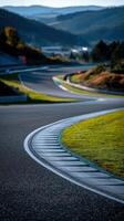 Winding race track curving through mountains on a sunny day photo