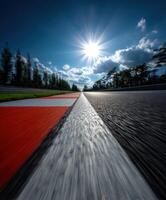 Racing track under bright sun with blue skies and clouds photo