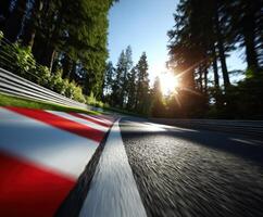 Racing on a winding road surrounded by trees at sunset photo