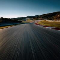 Racing track curves through hilly landscape at sunset photo