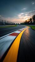 Curved racetrack with vibrant sunset in the background photo