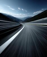 Curved racetrack winding through mountains in daylight photo