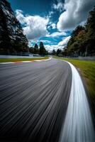 Race track curves under a blue sky with clouds photo