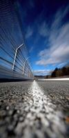 Racing track perspective with blue sky and distant mountains photo
