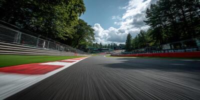 Racing track curves through lush green landscape in afternoon photo