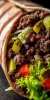 A close up of a burrito with meat and vegetables photo