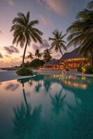 The pool at sunset at a resort in the maldives photo