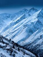 A snowy mountain range with trees and snow photo