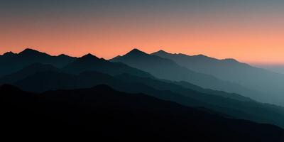 Mountains at sunset with a blue sky photo
