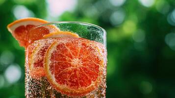 Refreshing citrus drink with bubbles in a glass photo