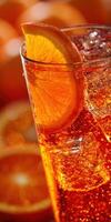 Refreshing orange beverage with ice in a clear glass photo