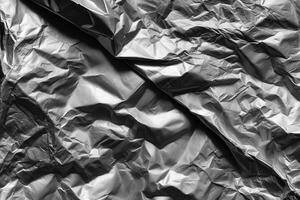 Crumpled silver foil resting on a flat surface photo